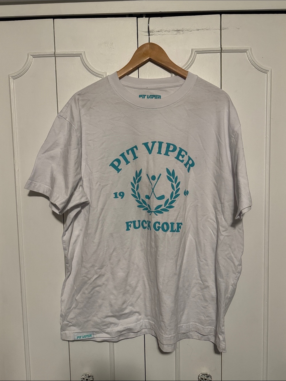 Pit Viper White Tee with Teal Crest Graphic and Bold Text
